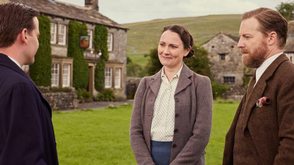 Nicholas Ralph as James Herriot; Anna Madeley as Mrs. Hall; Samuel West as Siegfried Farnon in All Creatures Great and Small Season 4