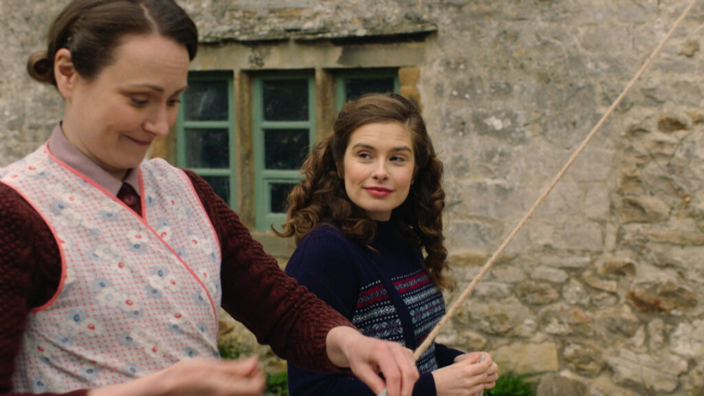 Mrs. Hall and Helen pinning clothes to the line