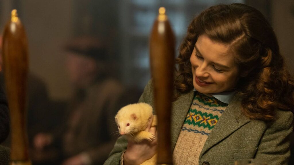 Helen Alderson affectionately holds the white ferret, Wilf