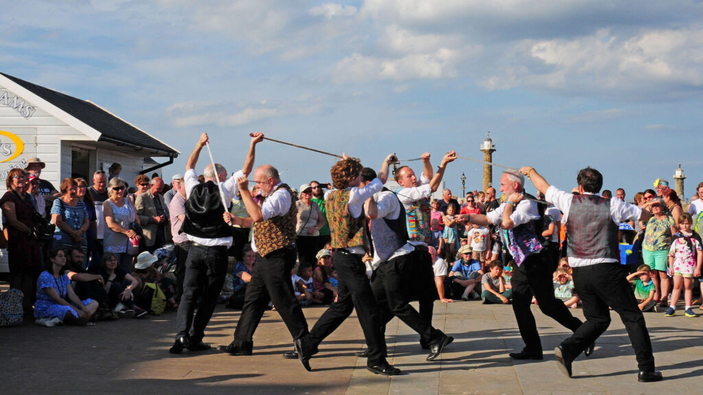 A photo depicting a team in the midst of their longsword dance in northern England.