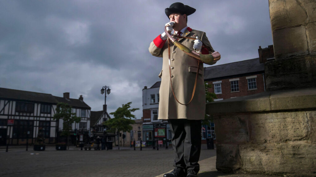Photo of Ripon City Hornblower blasts a horn, a centuries-old ceremonial role that started in this Yorkshire County UK town in AD 886.