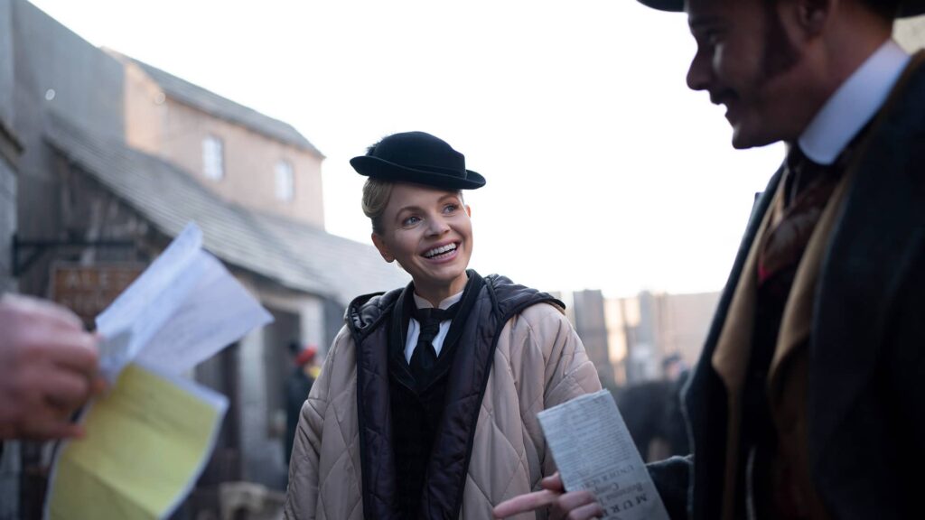 Kate Phillips smiling at Felix Scott behind the scenes of Miss Scarlet and The Duke Season 4