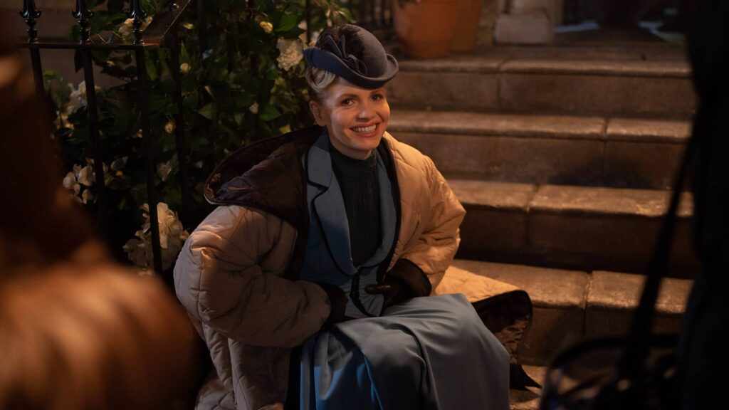 Kate Phillips sitting down behind the scenes of Miss Scarlet and The Duke Season 4