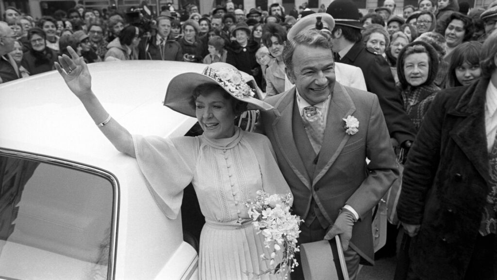 Black and white image of the 1975 wedding scene between characters Meg Richardson and Hugh Mortimer in the UK soap, Crossroads.