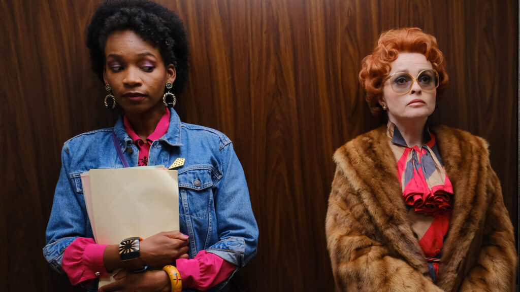 Color scene from the PBS MASTERPIECE miniseries, Nolly, showing actors Bethany Antonia (as Poppy Ngomo) and Helena Bonham-Carter (as Noele Gordon).