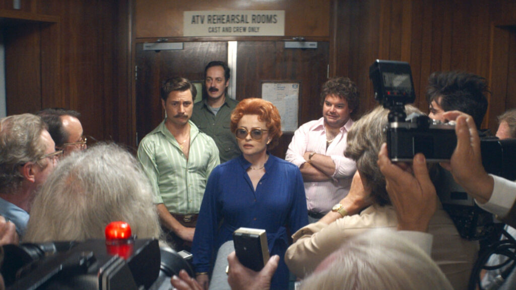Scene from the PBS MASTERPIECE miniseries, Nolly, showing Helena Bonham-Carter as Noele Gordon, in a press conference.