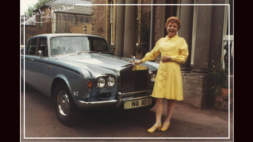 Color photo of Crossroads soap opera star Noele Gordon in front of her personal Rolls-Royce with its custom 
