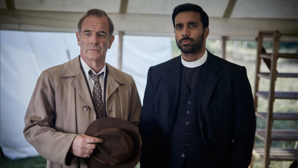 Actors Robson Green and Rishi Nair as DI Geordie Keating and Rev. Alphy Kottaram in Grantchester Season 9 on PBS MASTERPIECE.