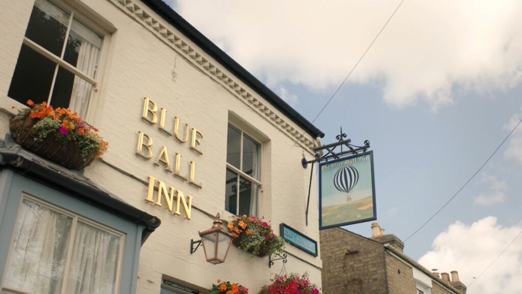 Color photo of the Blue Ball Inn's exterior in Grantchester, England.