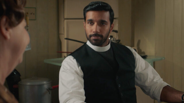 Rishi Nair as Alphy Kottaram speaking with Mrs. C. in Grantchester Season 9