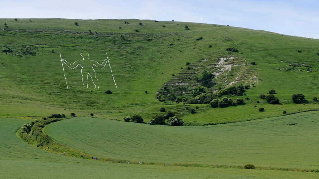 Color photo of a steep hill with the huge figure of the 