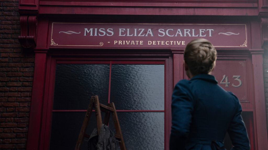 Kate Phillips as Eliza Scarlet reading her office sign in Miss Scarlet Season 4