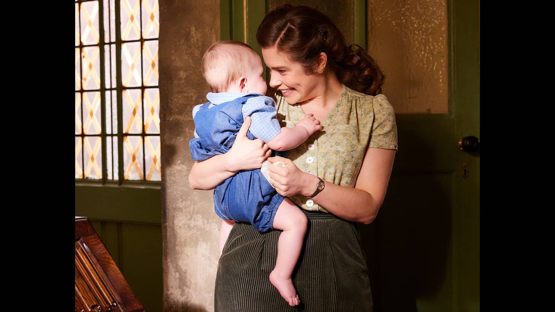 Helen Herriot holding baby Jimmy and smiling at him