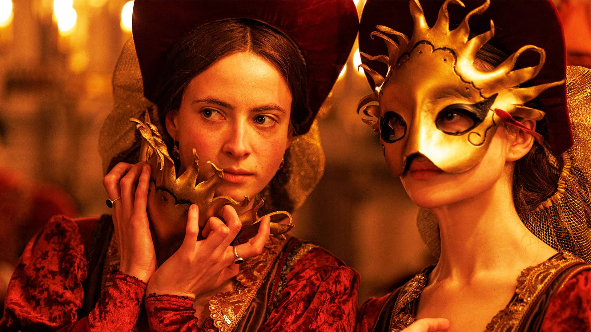Lady Margaret Douglas removes her mask to look across at the dancers with Mary FitzRoy.