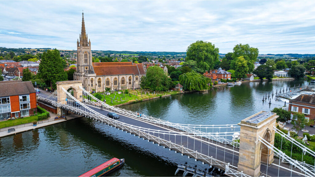 The Marlow Bridge spanning the River Thames with All Saint's Church in the background.