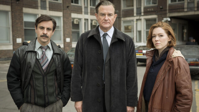 Actors (from left to right) Emun Elliott, Hugh Bonneville, and Charlotte Spencer in a scene from the true-crime drama The Gold airing on PBS MASTERPIECE.