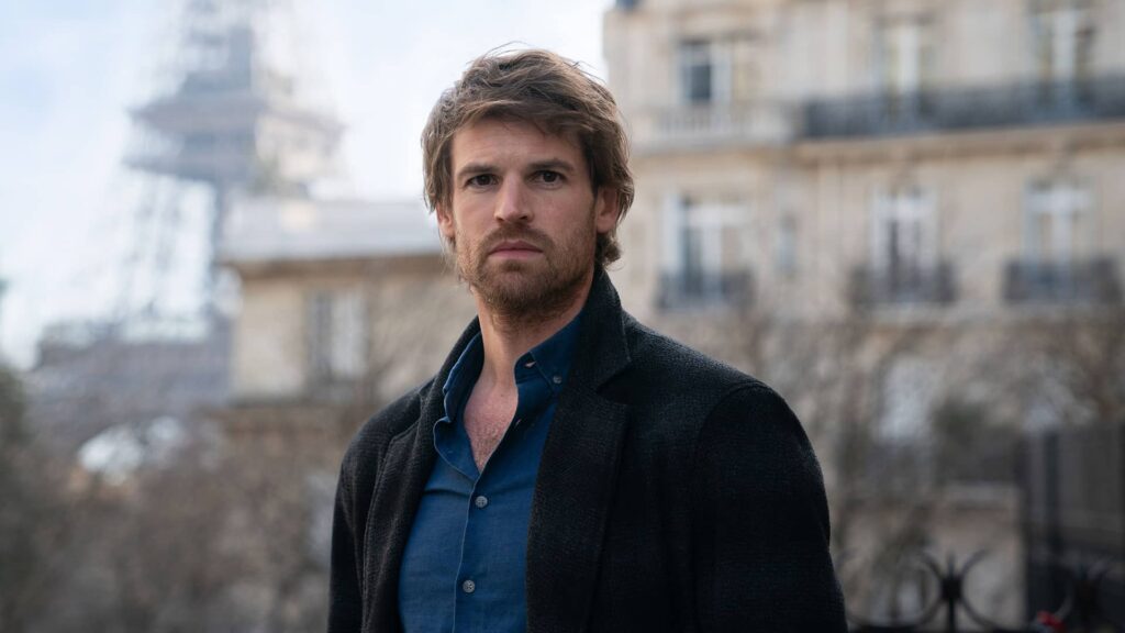 Benjamin Wainwright as Chief Inspector Jules Maigret looks directly at the camera with an intense, intelligent expression on his face.