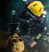 diver recovers ancient skull