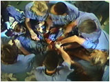 Image from show: the operating table from overhead, with staff close around table