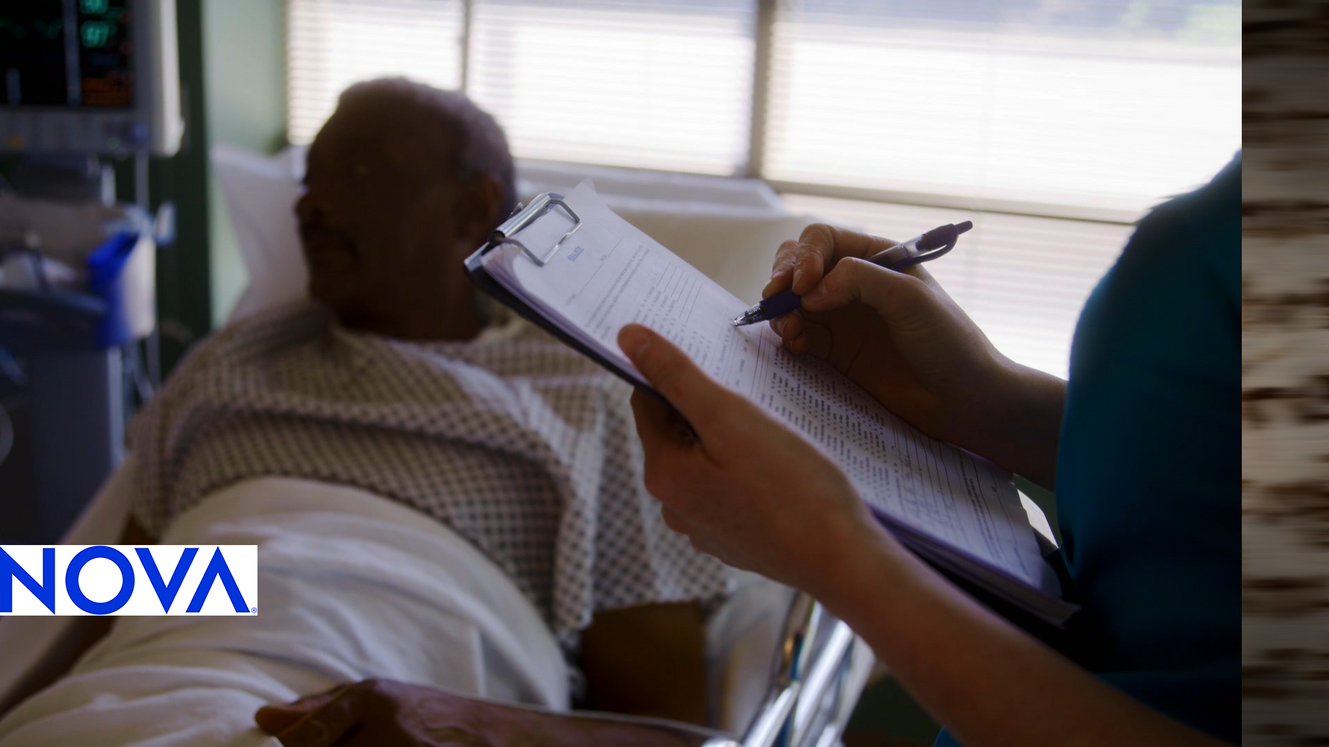 A doctor holds a clipboard over a patient