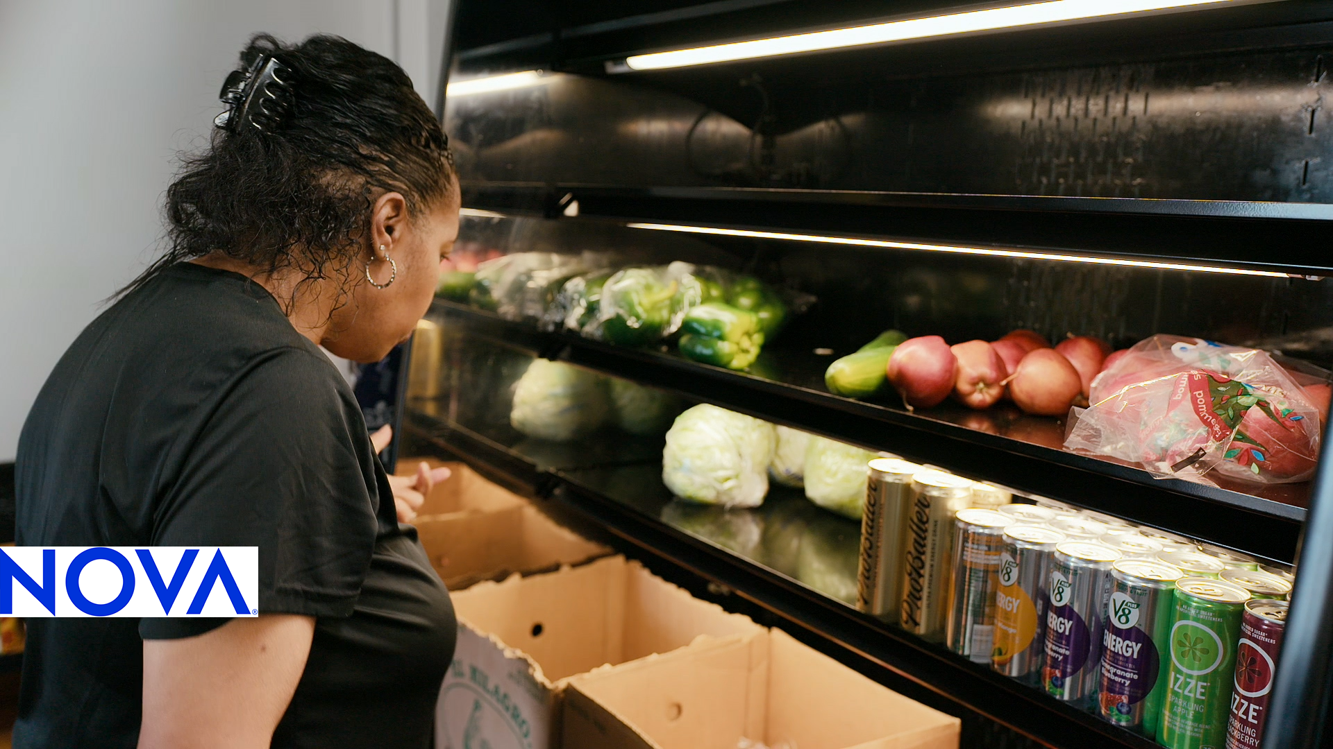 A woman shops for food in a local grocery store