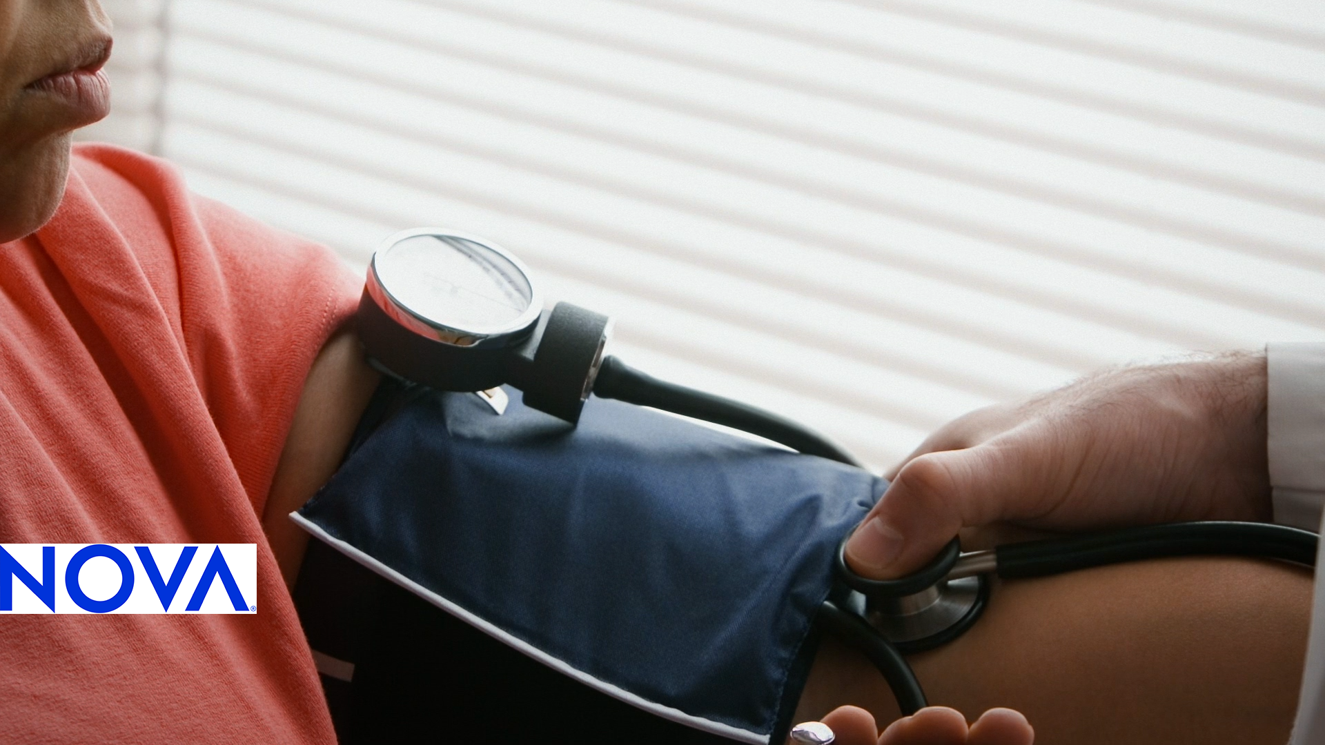 an image of a woman's arm in a blood pressure monitor cuff.