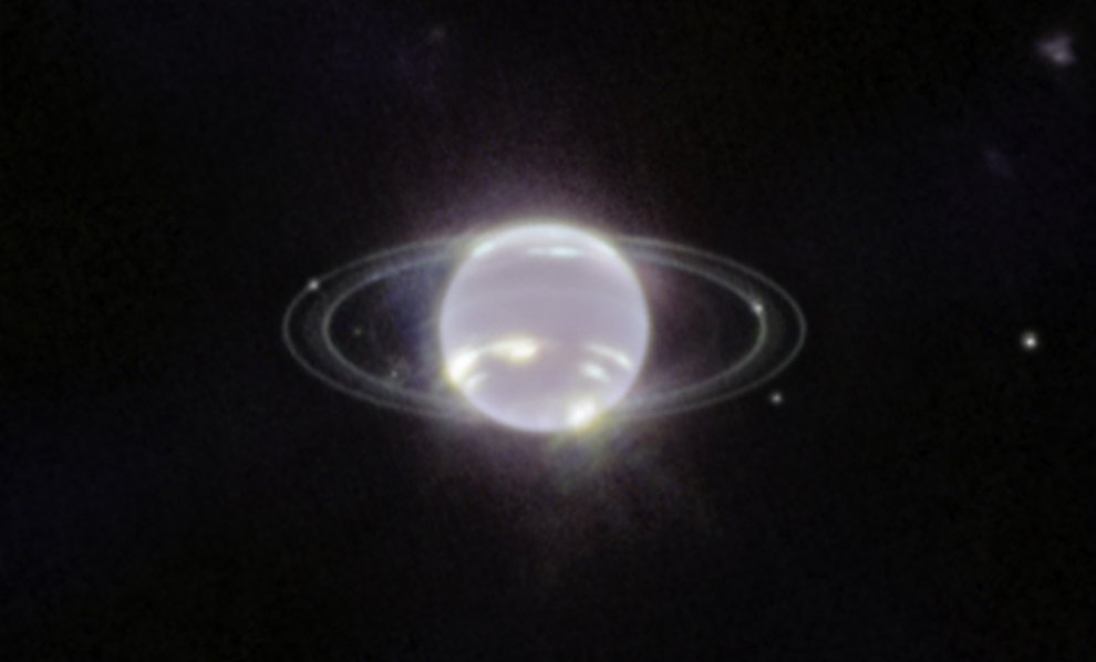 A glowing white ball with a few extra bright spots and thin luminescent rings against a black background