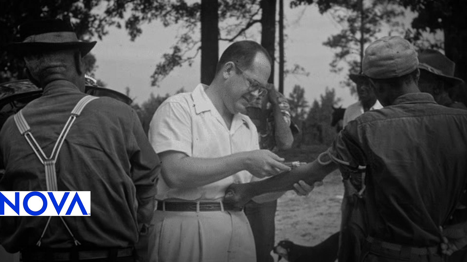 A white man draws blood from a black man