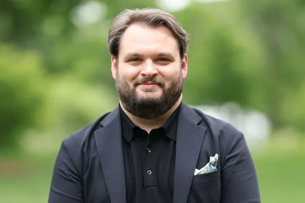 Color headshot photo of appraiser Tanner Branson with trees in background
