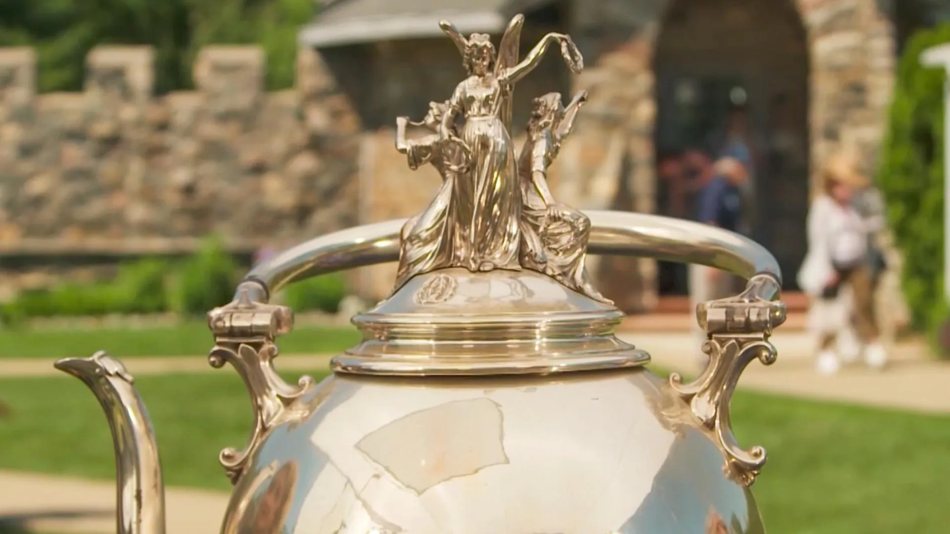 Close-up partial photo of a large silver teapot, circa 1872