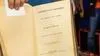 Book open to the first page with yellowed pages that reads " Unwritten History, Life Amongst the Modocs by Joaquin Miller"