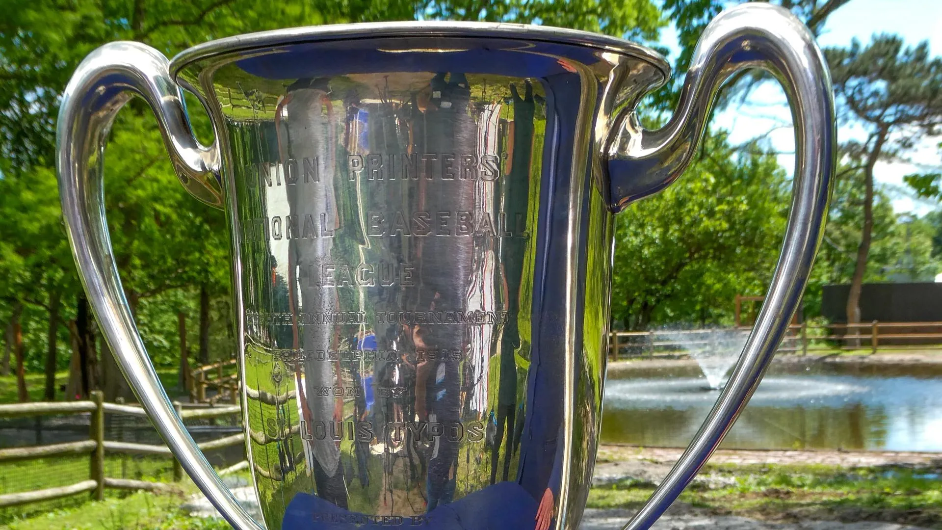 Close up on a silver trophy with the words "Union Printers National Baseball League" etched in it