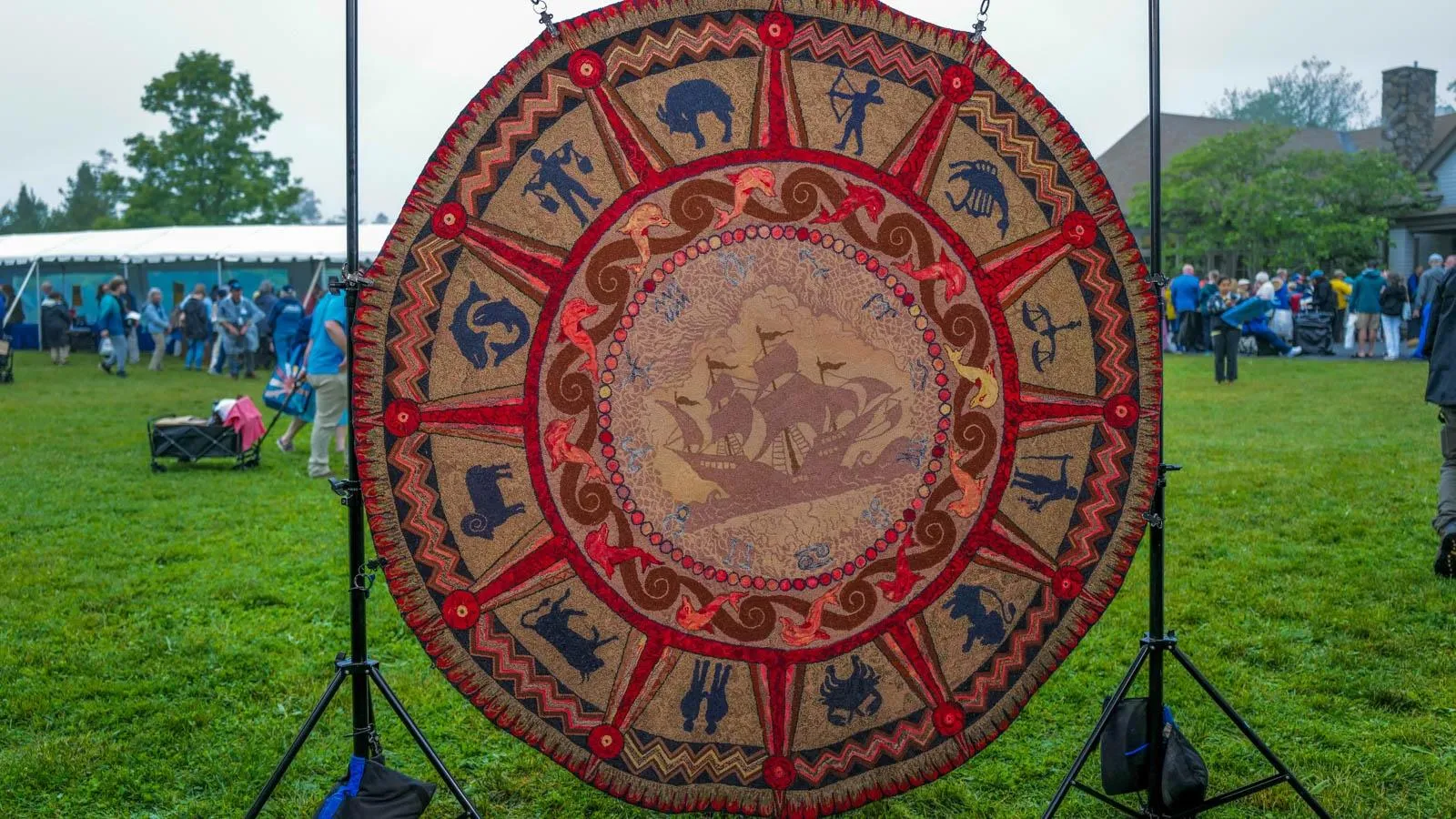 a zodiac rug of the 12 signs surrounding a boat.