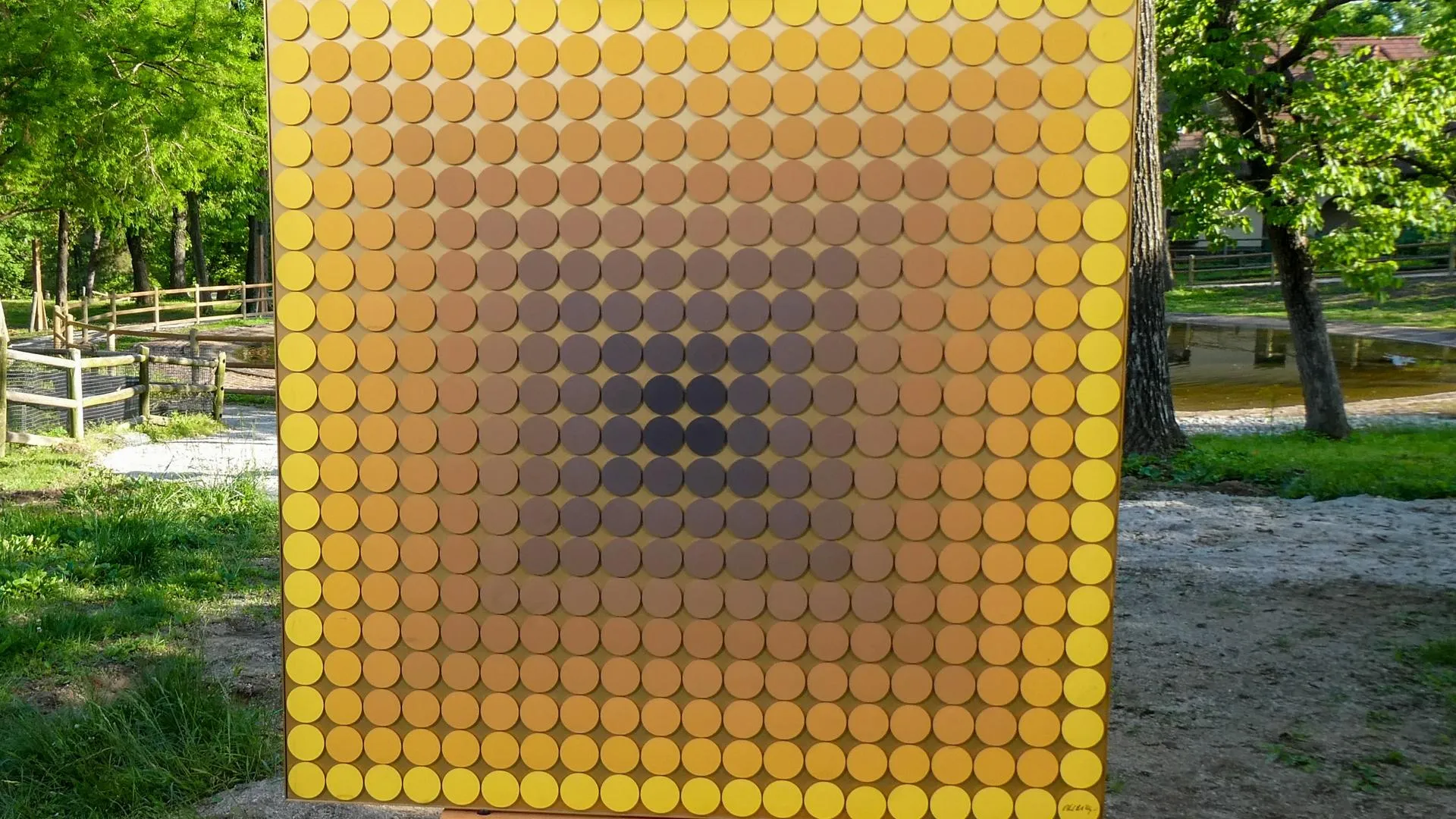 A close up of a square canvas of various circles in a gradient ranging from yellow to brown