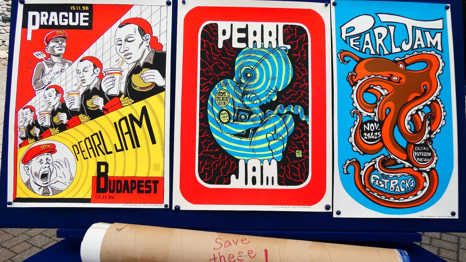 Close-up photo of a collection of colorful Pearl Jam promotional posters by Ames Bros
