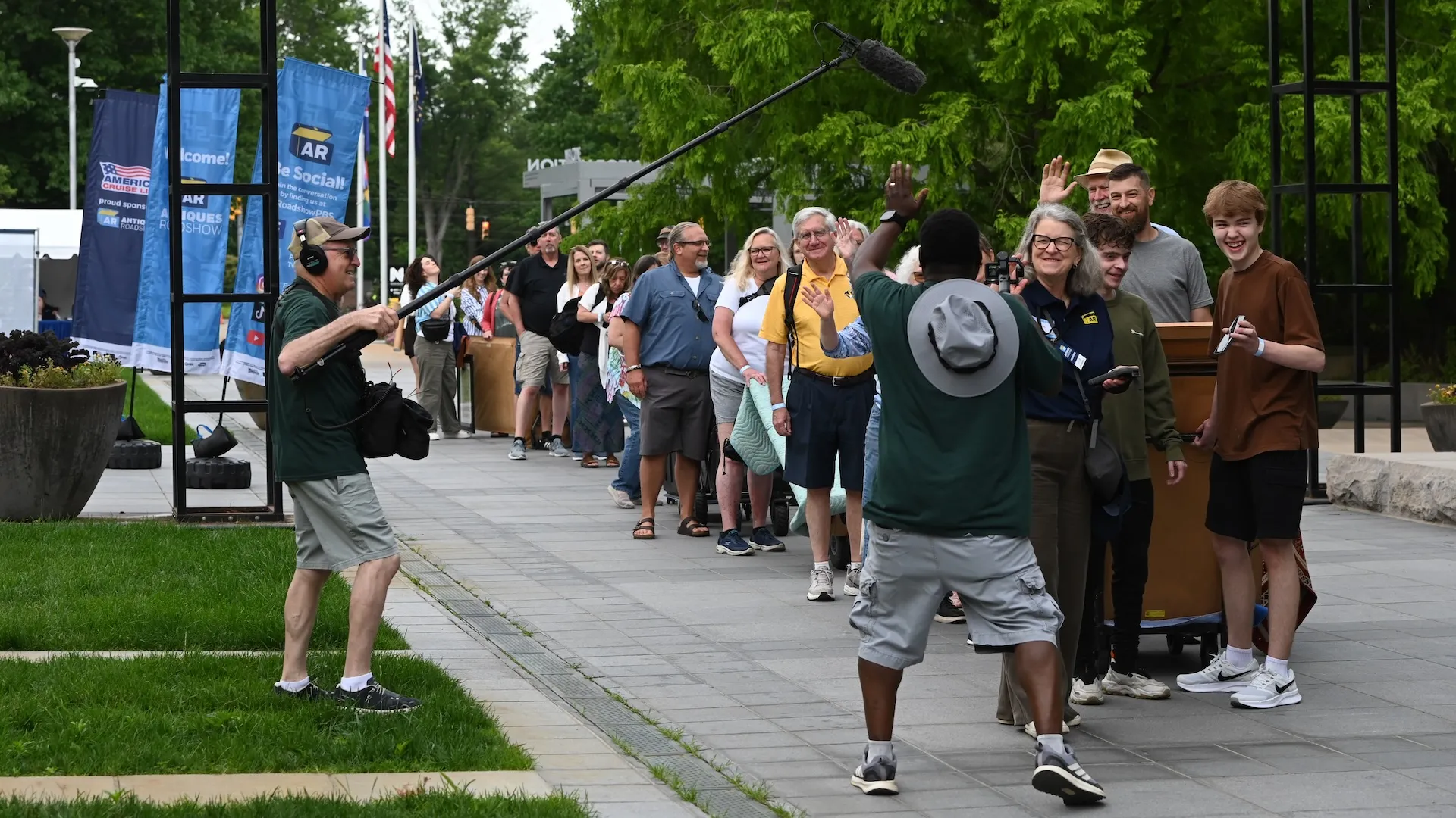 A photo of a line of guests being recorded by crew