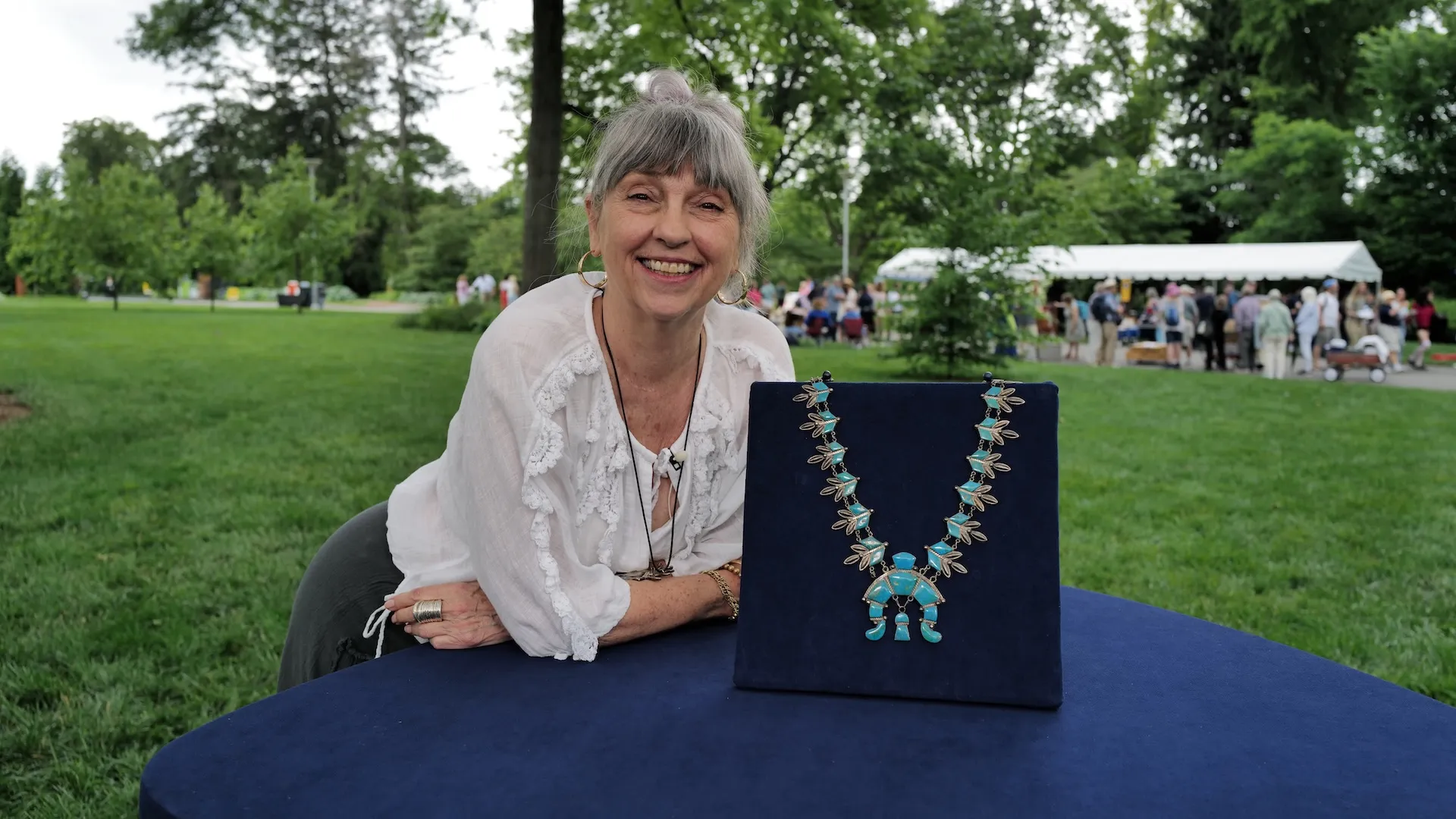 A photo of a guest and an appraised blue necklace