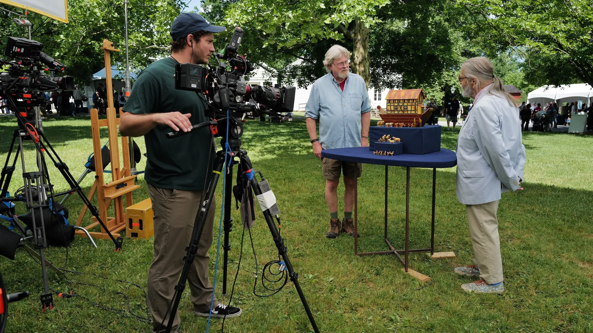 A photo of an appraisal of a Noah's Ark toy with camera crew in view
