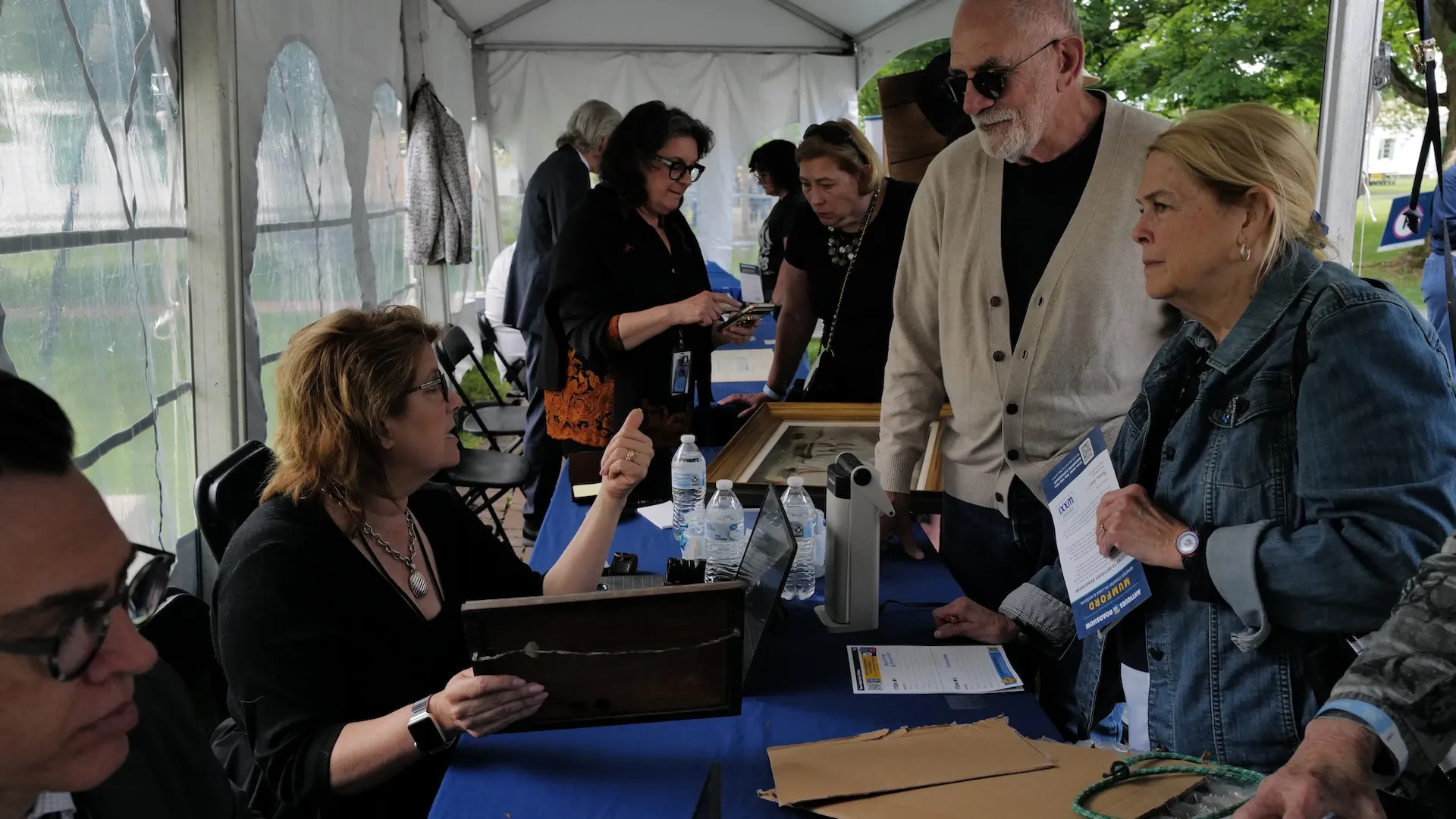 A photo of the appraisal table with an appraiser talking to guests