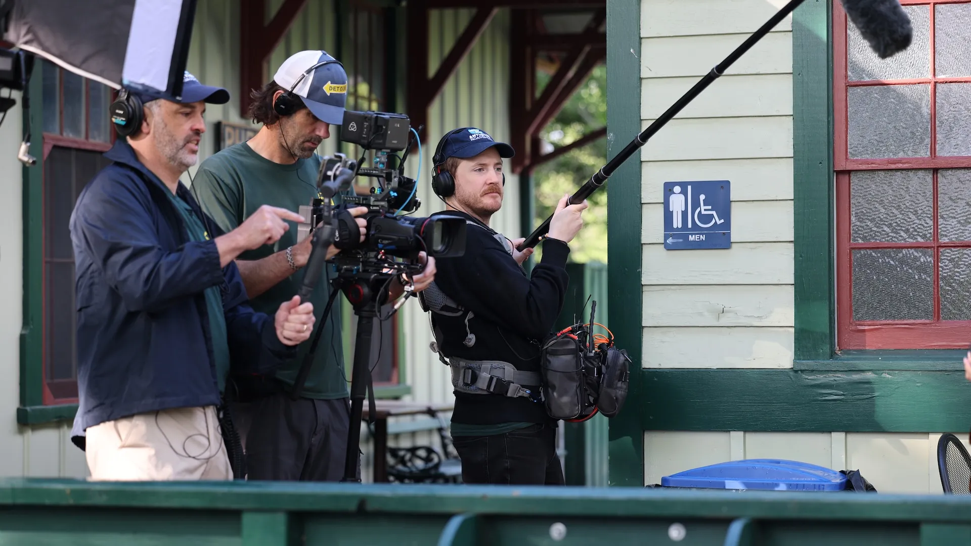 A photo of the crew with a camera and boom microphone
