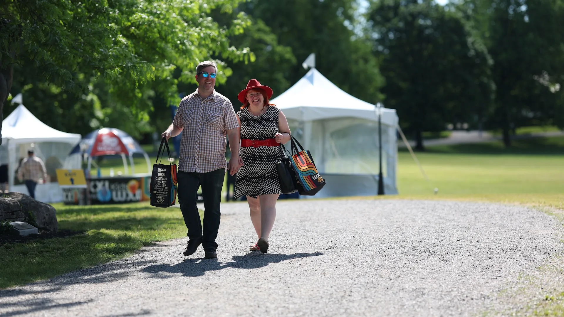 A photo of two guests smiling and walking down the path