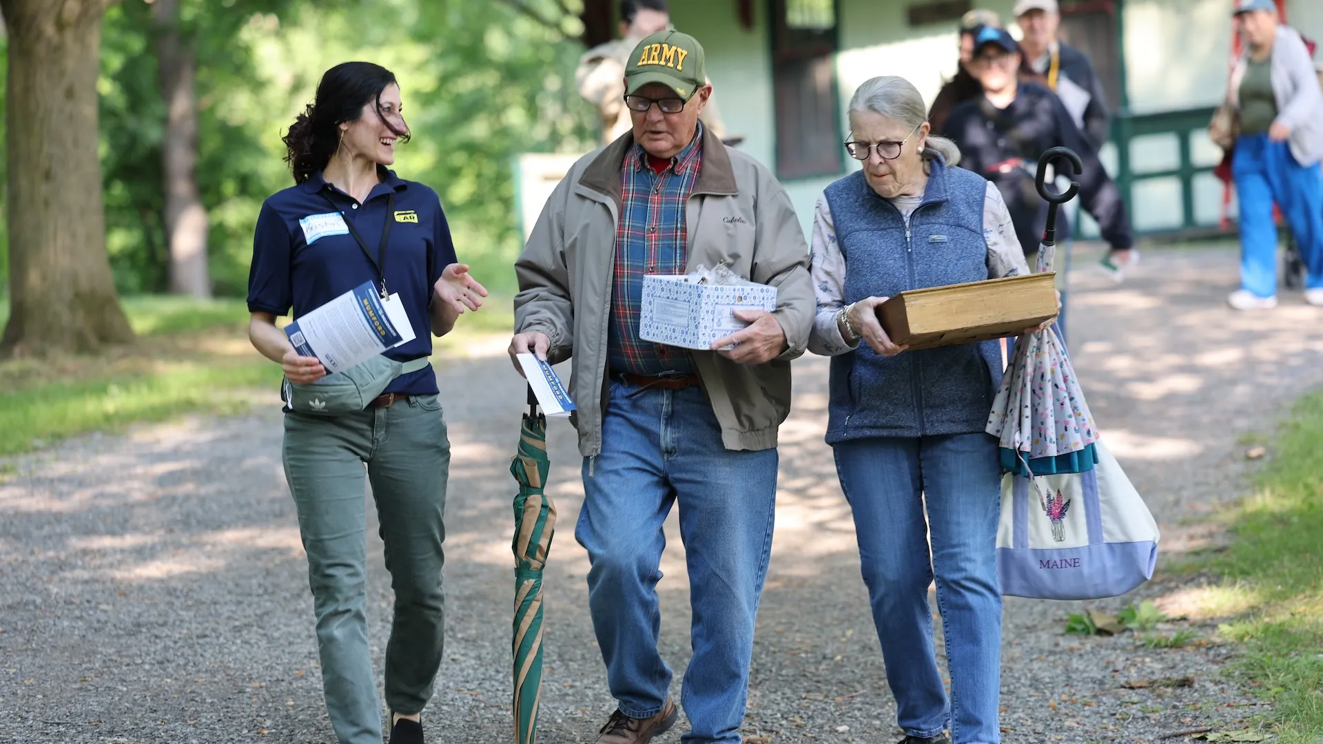A photo of a volunteer walking alongside two guests