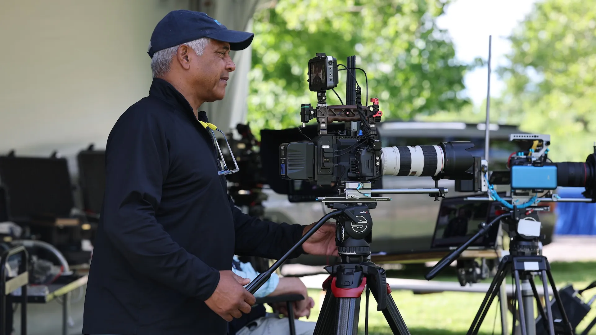 A photo of a camera operator with a large camera