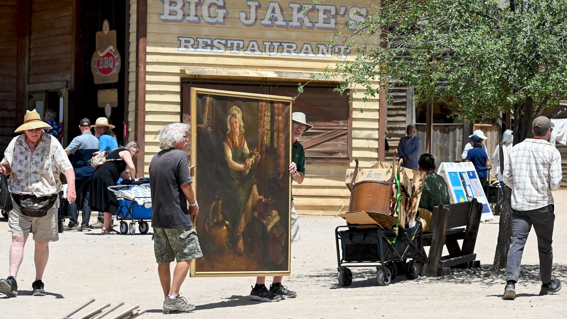 A photo of a large portrait being carried down the path