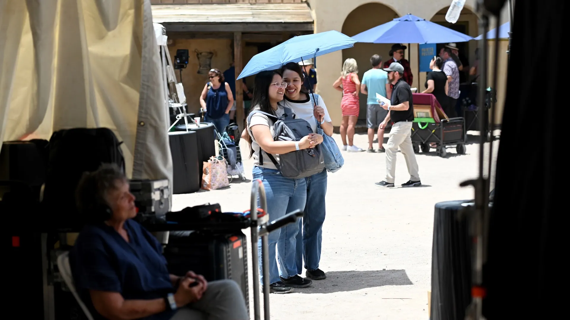 A photo of two guests under an umbrella