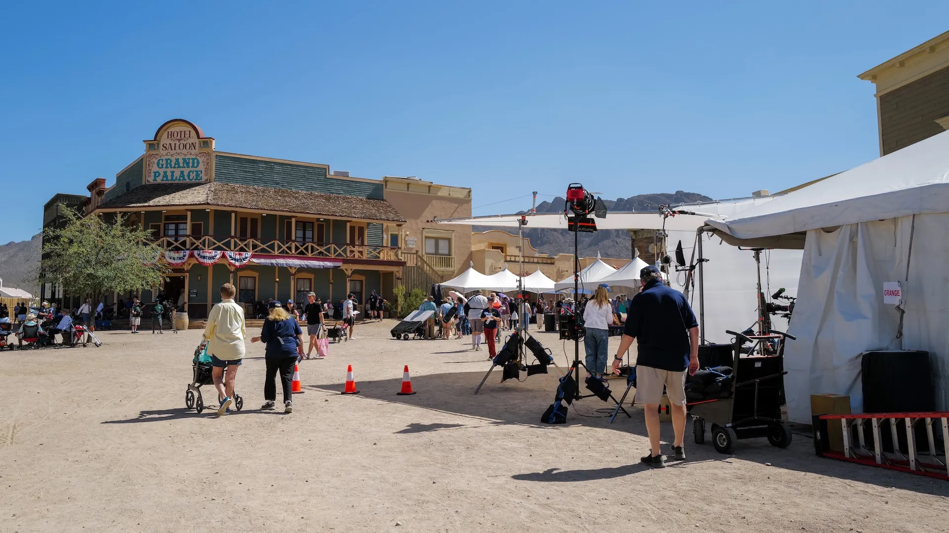 A wide photo of the venue with guests walking and crew gear in view