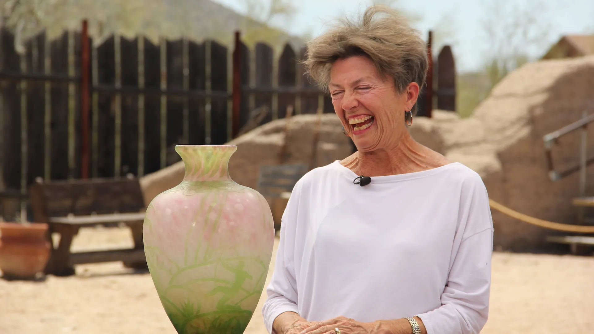 An excited photo of a guest with a vase being appraised