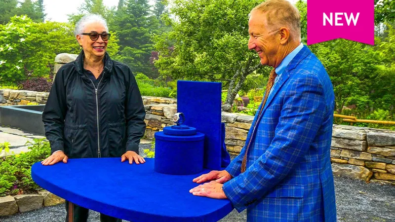 color photo of a lady and discussing a watch with appraiser Paul Winicki