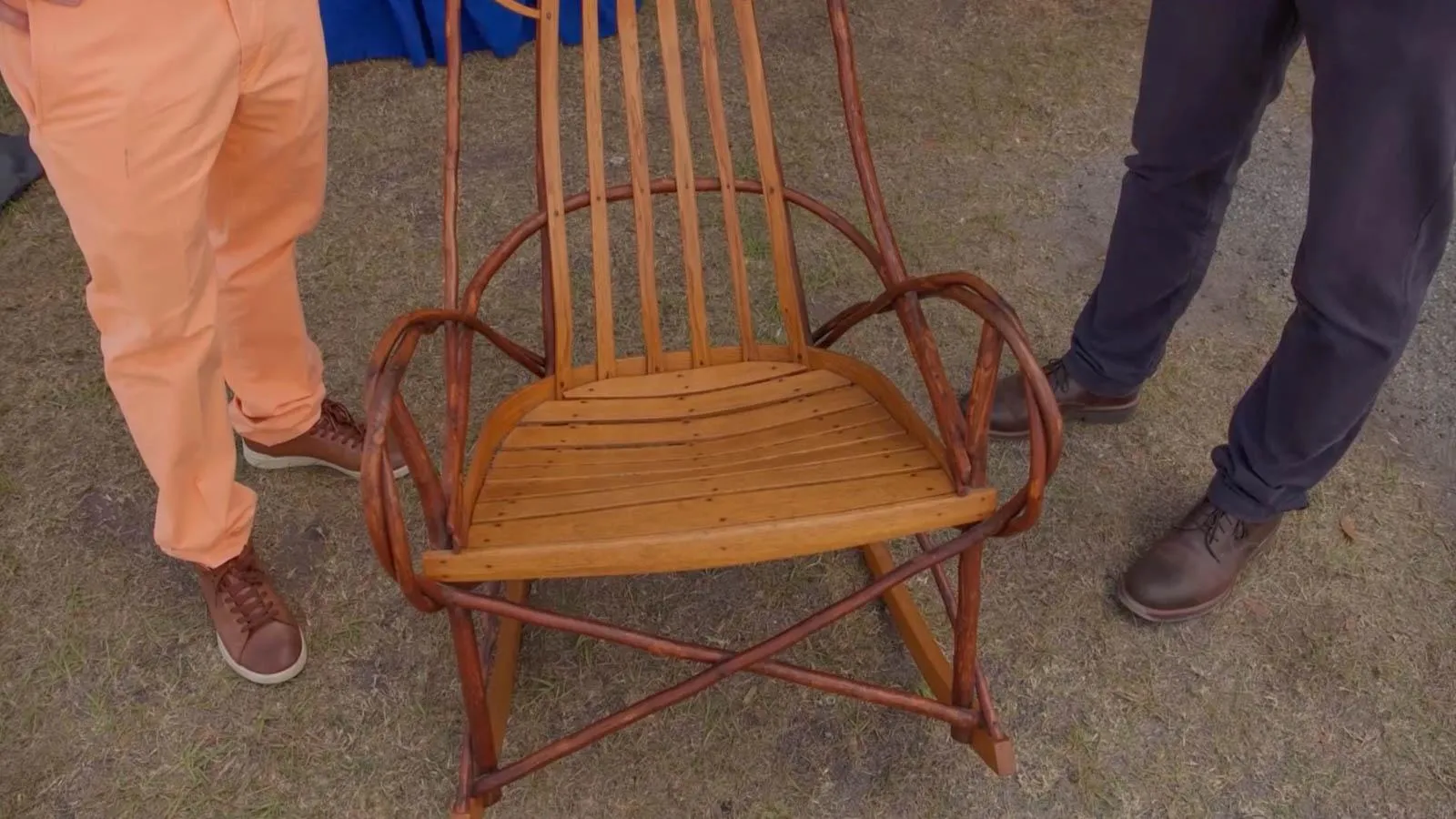 close up of a wooden rocking chair with both light and dark color wood.