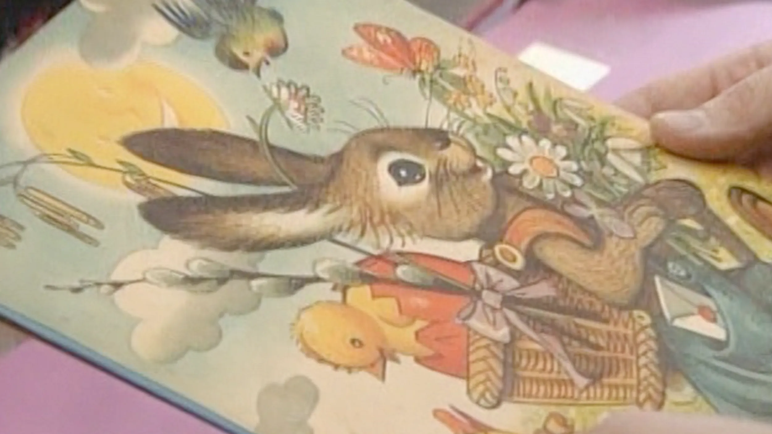 Close up on a drawing of a bunny carrying a basket.